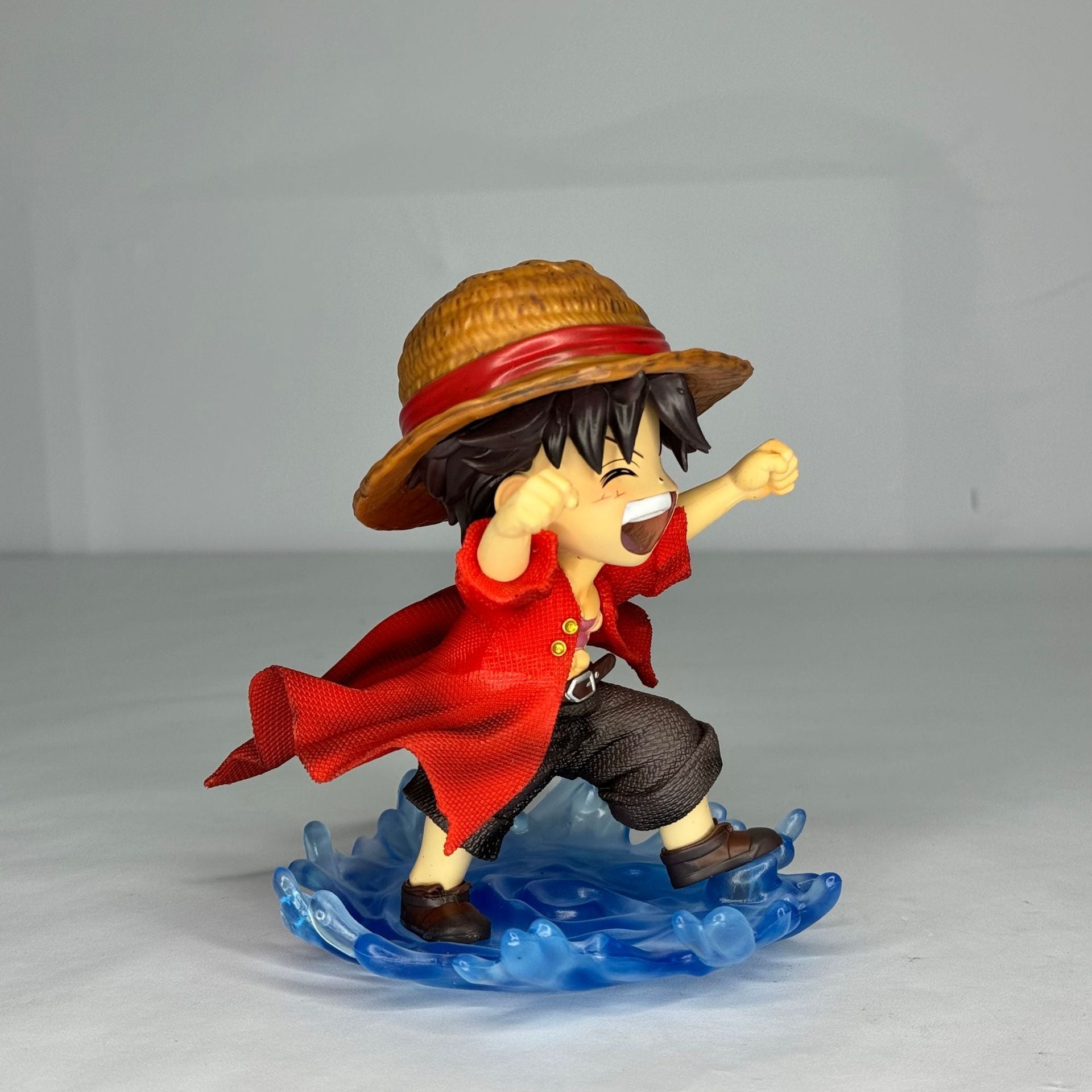 An angled view of the Monkey D. Luffy laughing statue, highlighting the dynamic details of his pose and the Water Moon style.